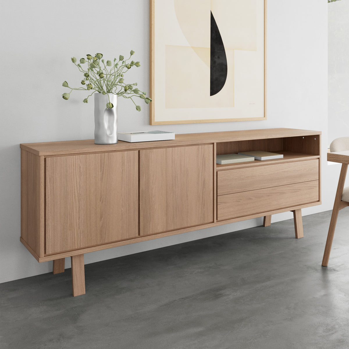 Lurisse chest of drawers, 200x75, bleached oak, positioned beneath a print against a grey wall, with a vase and books – a chest of drawers for the living room