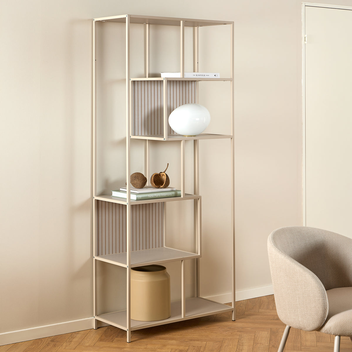 Skeleto bookcase, 77x185, grey melamine, in a bright room next to an armchair, with a spherical lamp – a bookcase for the living room