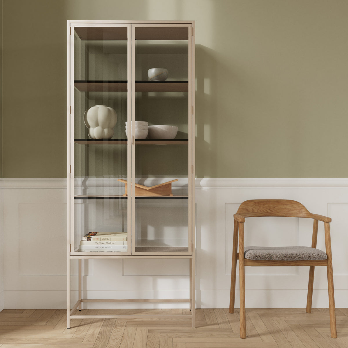 Skeleto 77x186 Grey Melamine display cabinet against an olive-coloured wall next to a wooden chair – a display cabinet for ceramics and books