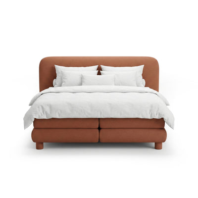 Continental bed with a rounded headboard in a modern organic style | Portela