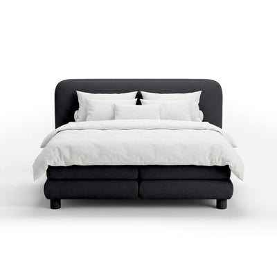 Continental bed with a rounded headboard in a modern organic style | Portela