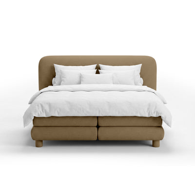 Continental bed with a rounded headboard in a modern organic style | Portela