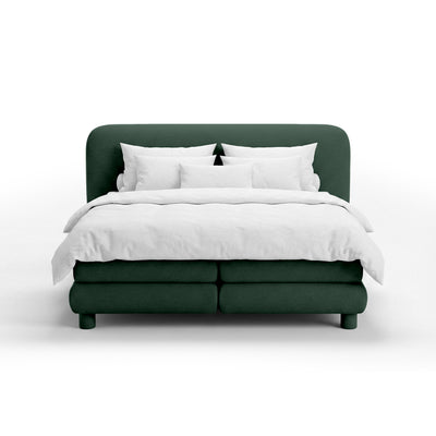 Continental bed with a rounded headboard in a modern organic style | Portela