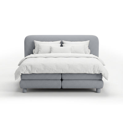 Continental bed with a rounded headboard in a modern organic style | Portela