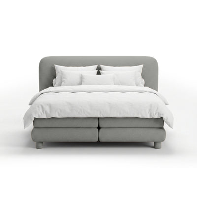 Continental bed with a rounded headboard in a modern organic style | Portela