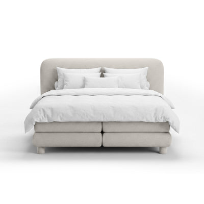 Continental bed with a rounded headboard in a modern organic style | Portela