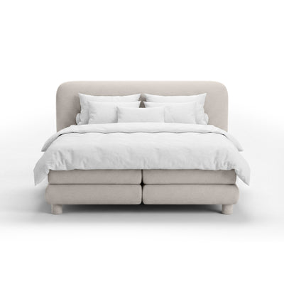 Continental bed with a rounded headboard in a modern organic style | Portela
