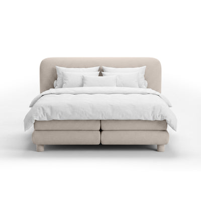 Continental bed with a rounded headboard in a modern organic style | Portela