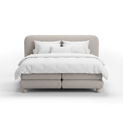 Continental bed with a rounded headboard in a modern organic style | Portela