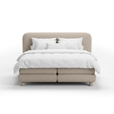 Continental bed with a rounded headboard in a modern organic style | Portela