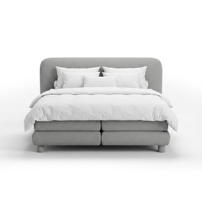 Continental bed with a rounded headboard in a modern organic style | Portela