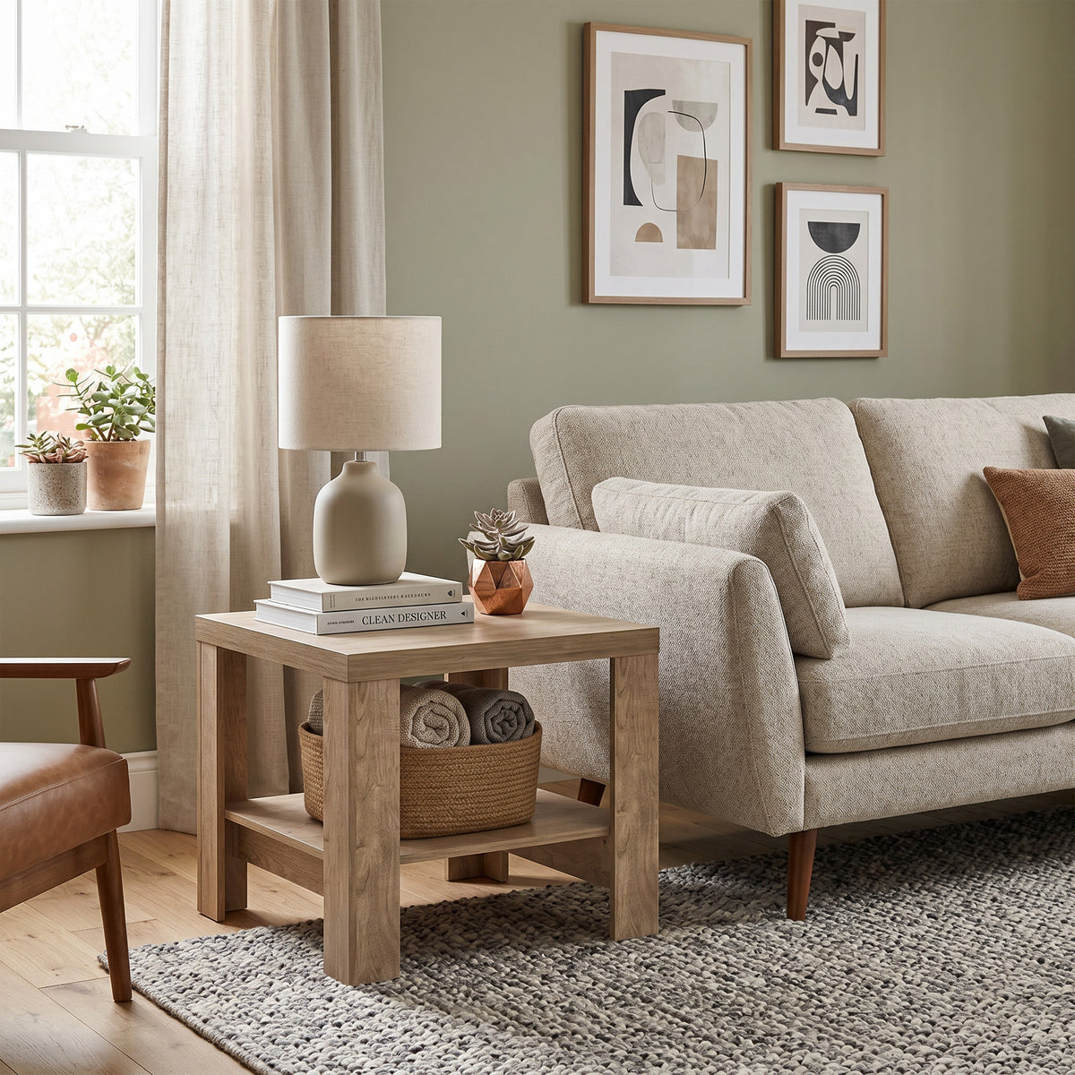 Korin coffee table 65x57 in a living room with a bouclé sofa and a leather armchair – small living room coffee table