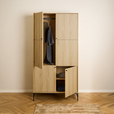 Bambouz wardrobe, 99x200, on a herringbone-patterned floor – open doors, clothes on a rail and jumpers on a shelf, bedroom wardrobe