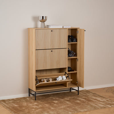 A Bambouz 99x141 shoe cupboard in a bright hallway on a carpet – open doors, shelves with shoes and a compartment with a hinged door