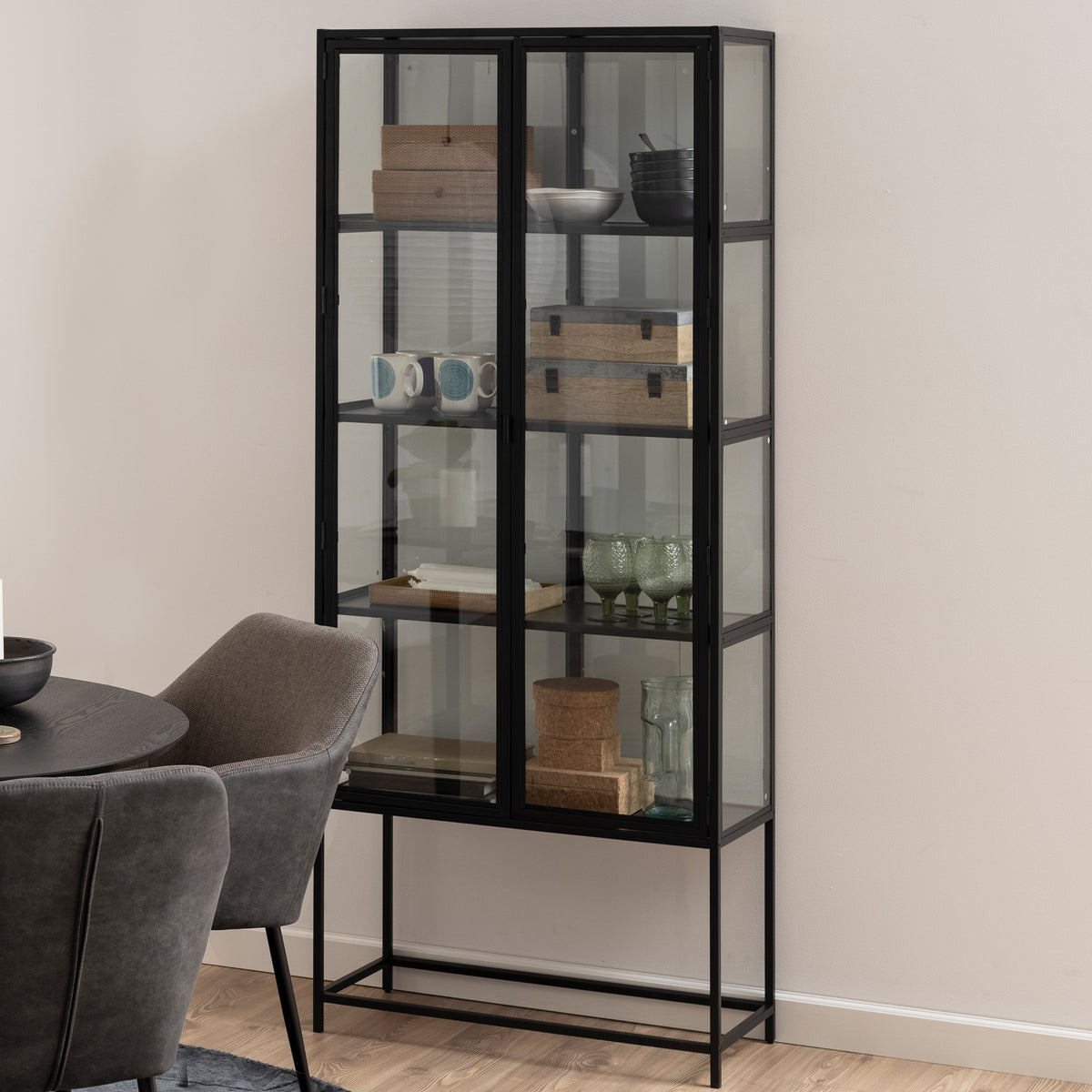 Skeleto 77x186 Black Melamine display cabinet in the dining room next to a round table – an industrial-style display cabinet for tableware