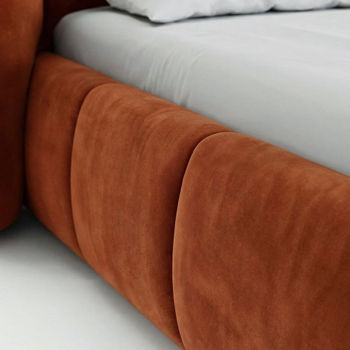 Upholstered bed with vertical tufting and storage in a soft modern style | Ventara